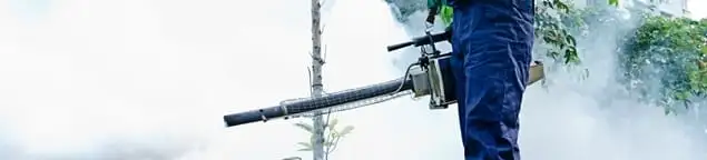 Pest control technician fogging an outdoor area for insect control in Wichita, KS