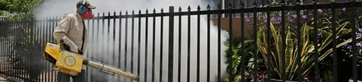 Mosquito control technician fogging a yard perimeter for mosquito reduction in Wichita, KS